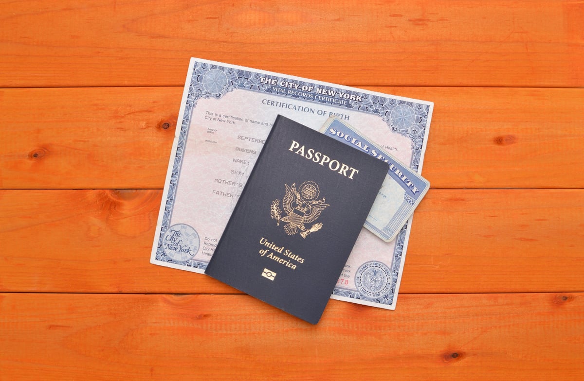 US Passport, Social Security Card and Birth Certificate on wood table